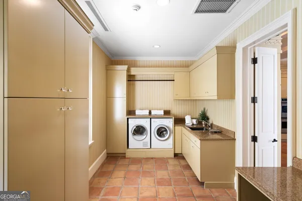 an aerial view of a house with swimming pool big yard and a large tree