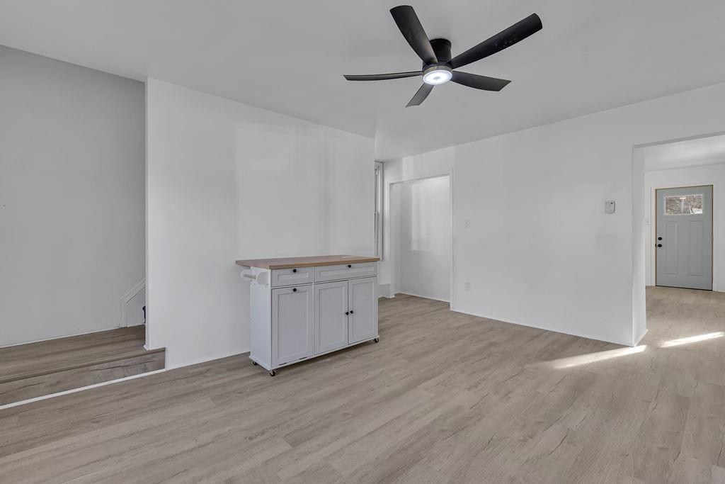 498 Blockhouse Run Road New Brighton, PA 15066 - Photo 12 of 23 an empty room with wooden floor and a ceiling fan