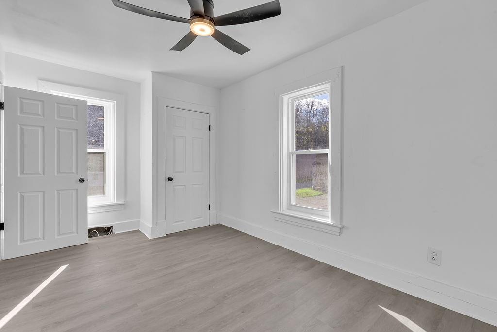 498 Blockhouse Run Road New Brighton, PA 15066 - Photo 19 of 23 an empty room with a window and ceiling fan