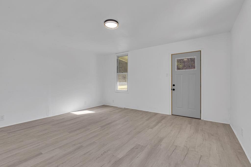 498 Blockhouse Run Road New Brighton, PA 15066 - Photo 20 of 23 an empty room with wooden floor and windows