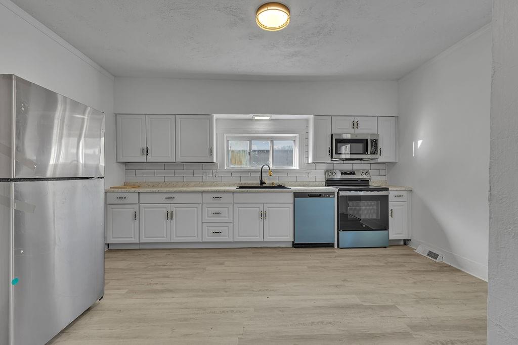 498 Blockhouse Run Road New Brighton, PA 15066 - Photo 5 of 23 a kitchen with stainless steel appliances granite countertop a refrigerator sink and stove