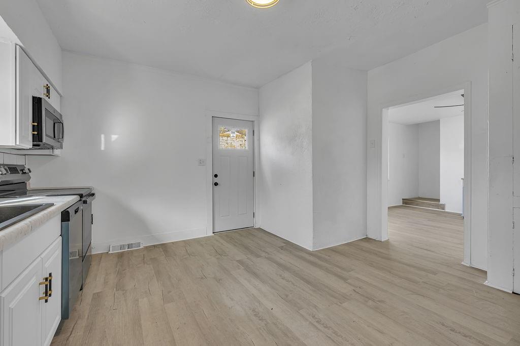 498 Blockhouse Run Road New Brighton, PA 15066 - Photo 7 of 23 a view of empty room with wooden floor and fan