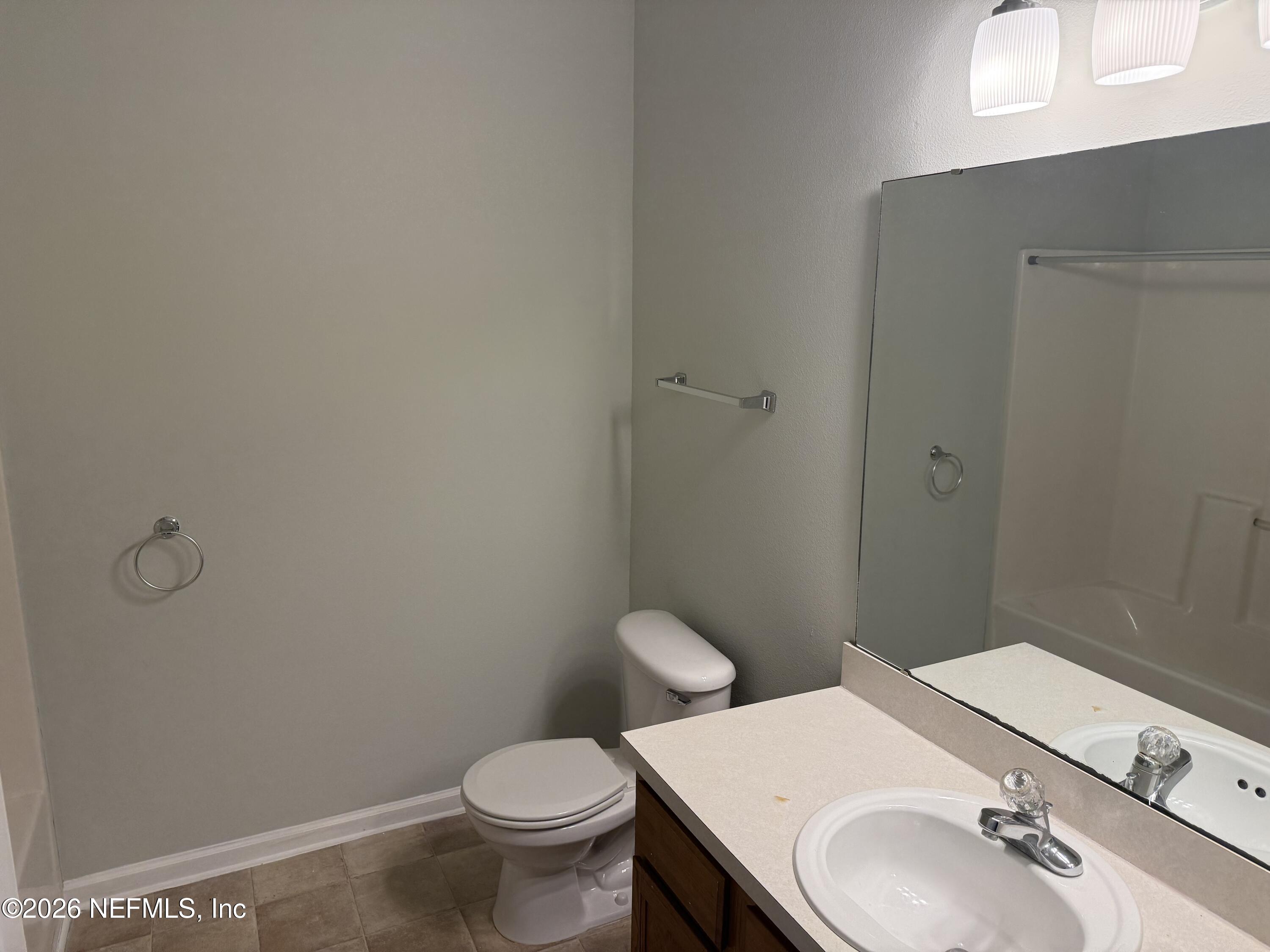 7920 Merrill Road, Unit 403 Jacksonville, FL 32277 - Photo 11 of 18 a bathroom with a sink toilet and vanity