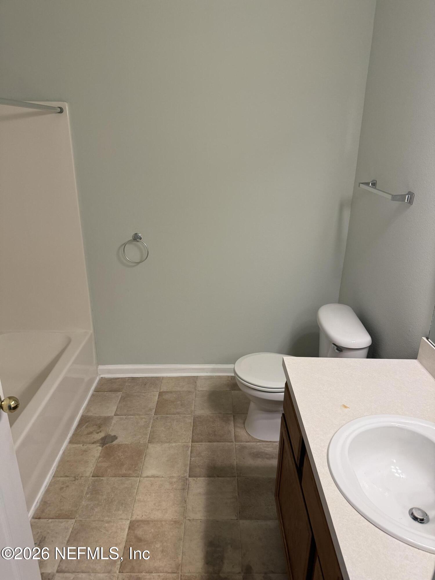 7920 Merrill Road, Unit 403 Jacksonville, FL 32277 - Photo 12 of 18 a bathroom with a sink a toilet and vanity