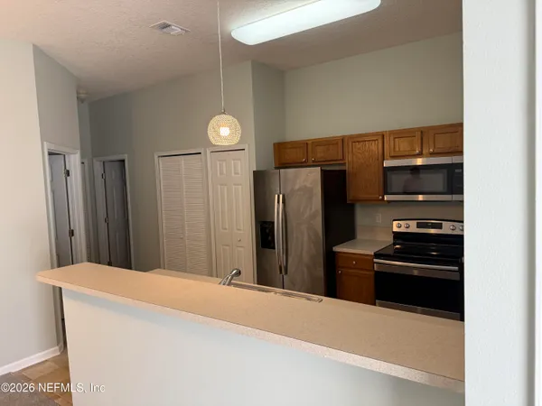 an empty room with windows and closet