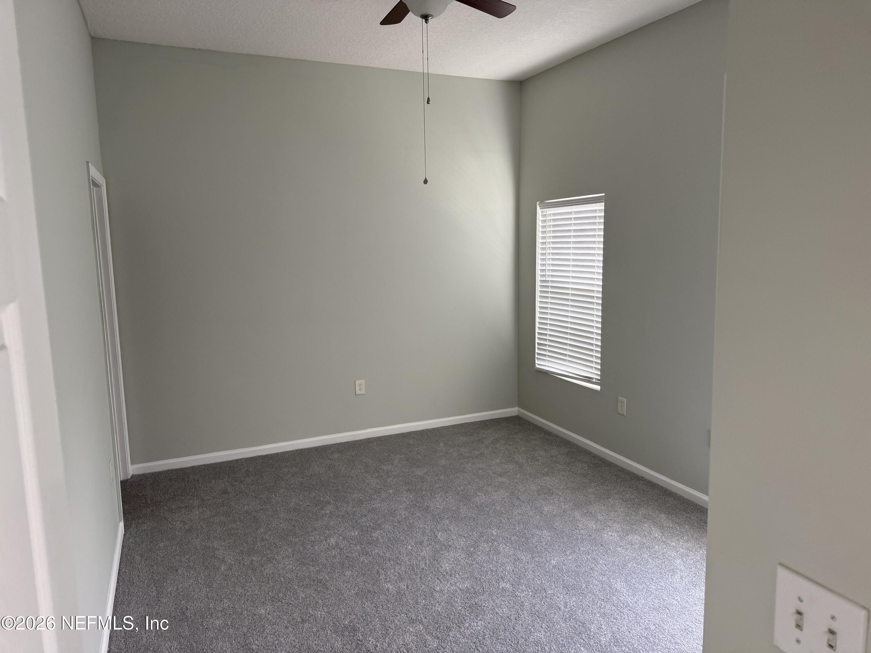 7920 Merrill Road, Unit 403 Jacksonville, FL 32277 - Photo 16 of 18 an empty room with a window and a fan