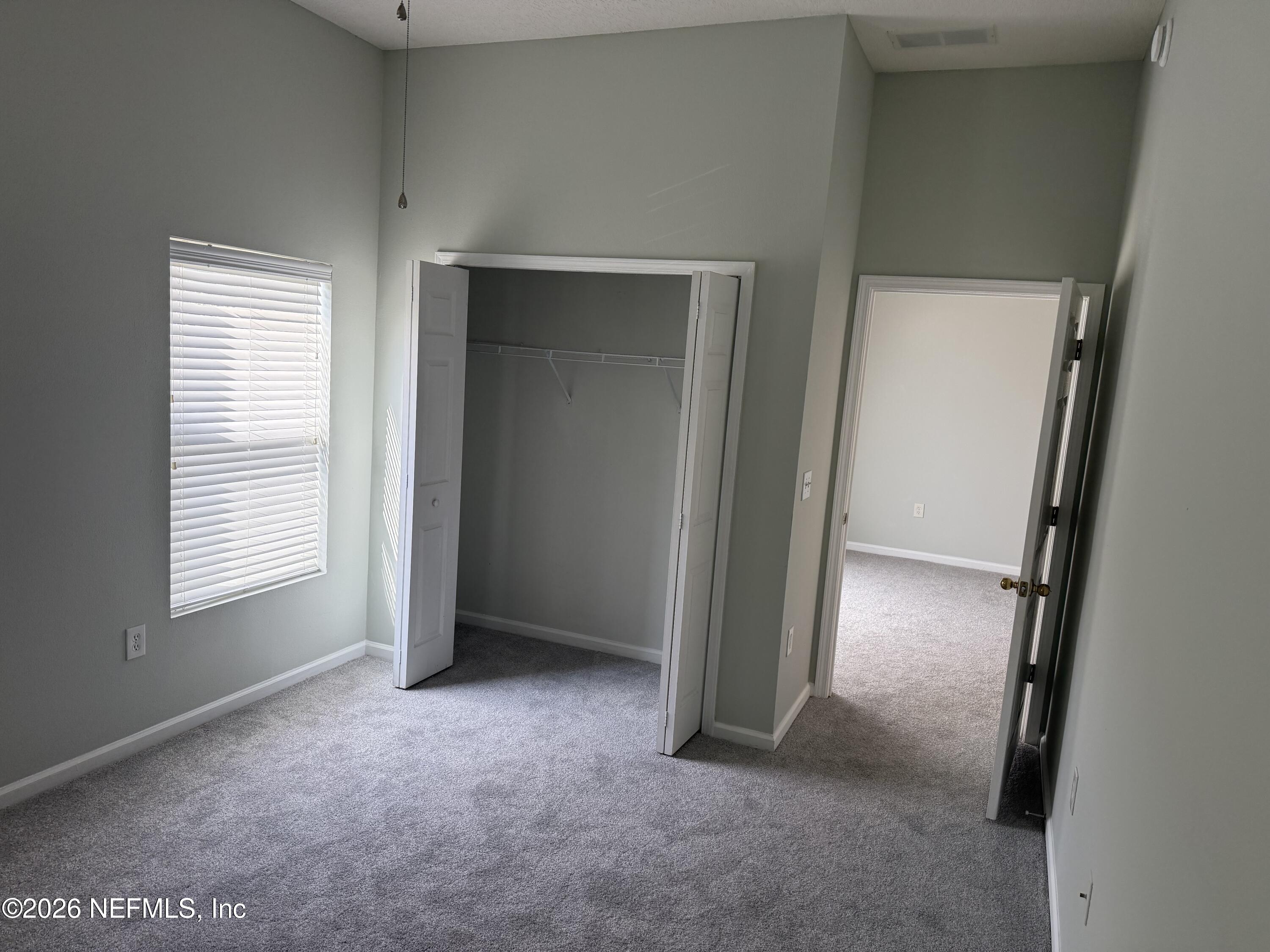 7920 Merrill Road, Unit 403 Jacksonville, FL 32277 - Photo 17 of 18 an empty room with windows and closet