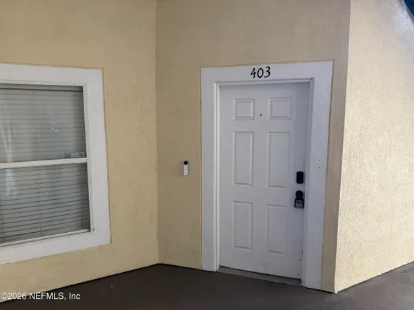 an empty room with a ceiling fan and carpet