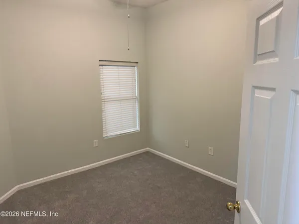 a view of a hallway with washer and dryer
