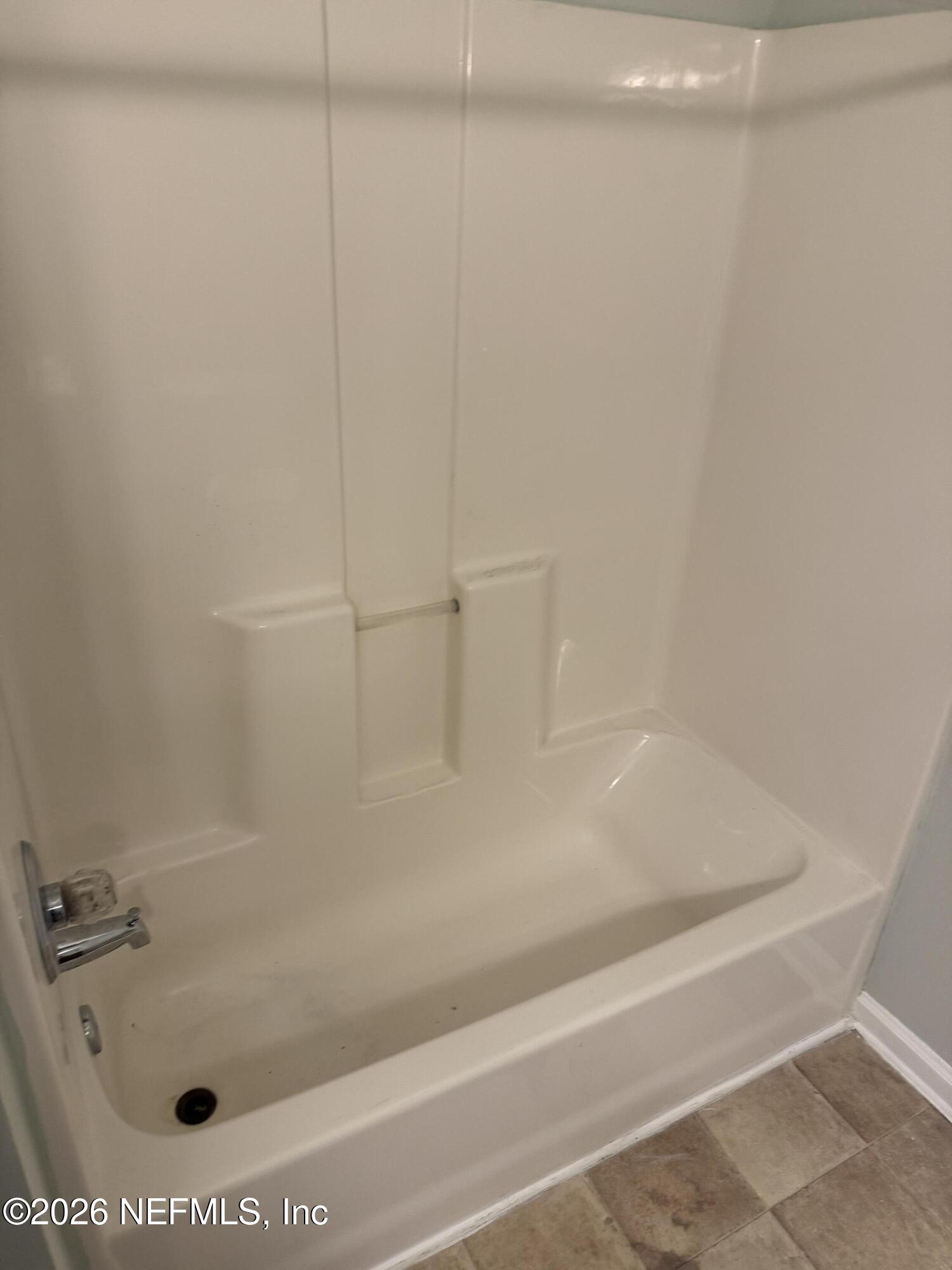 7920 Merrill Road, Unit 403 Jacksonville, FL 32277 - Photo 10 of 18 a bath tub with a shower