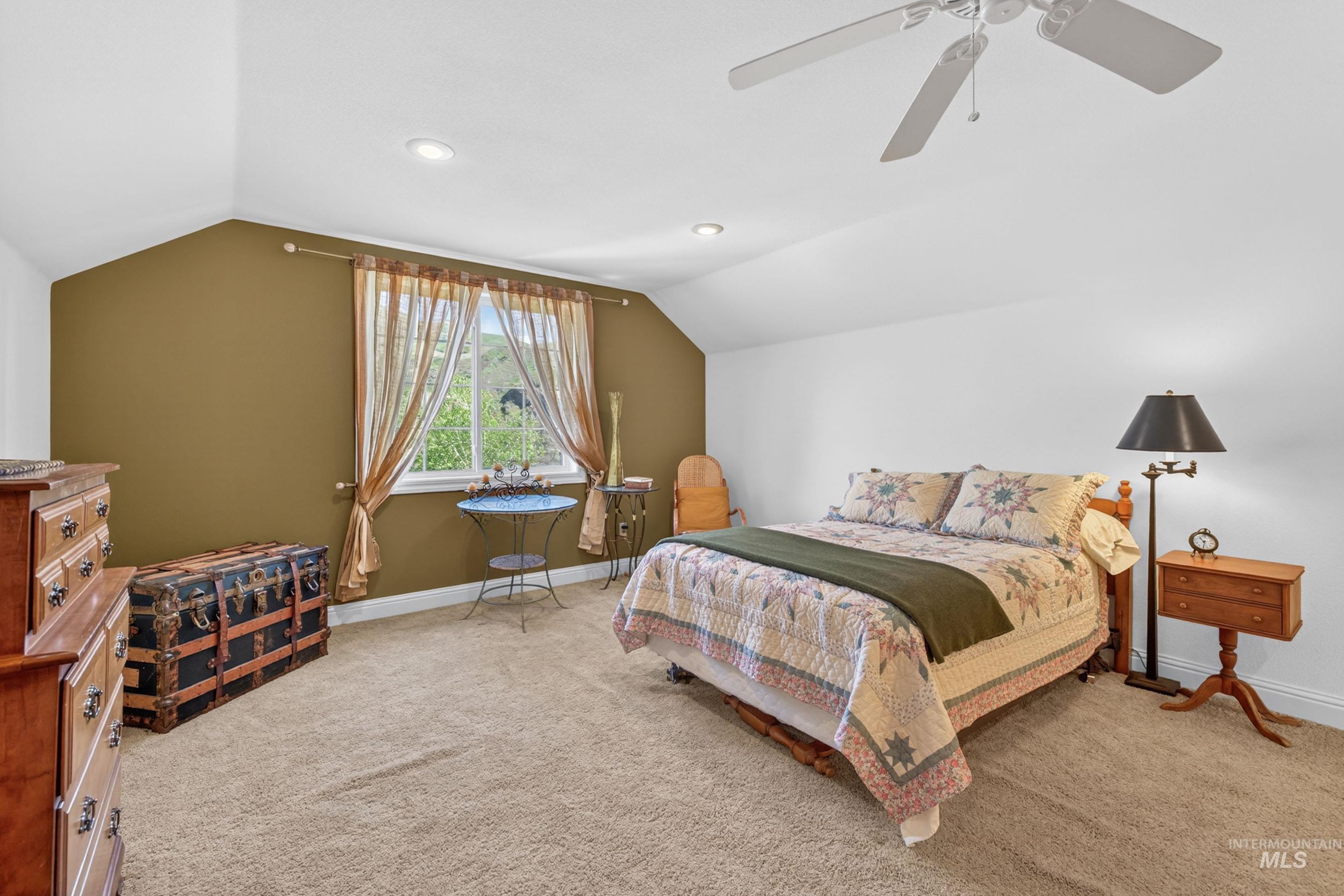 113 Deford Road White Bird, ID 83554 - Photo 26 of 49 Carpeted room featuring a window with a green outdoor backdrop, sloped ceiling, recessed lighting, and a ceiling fan