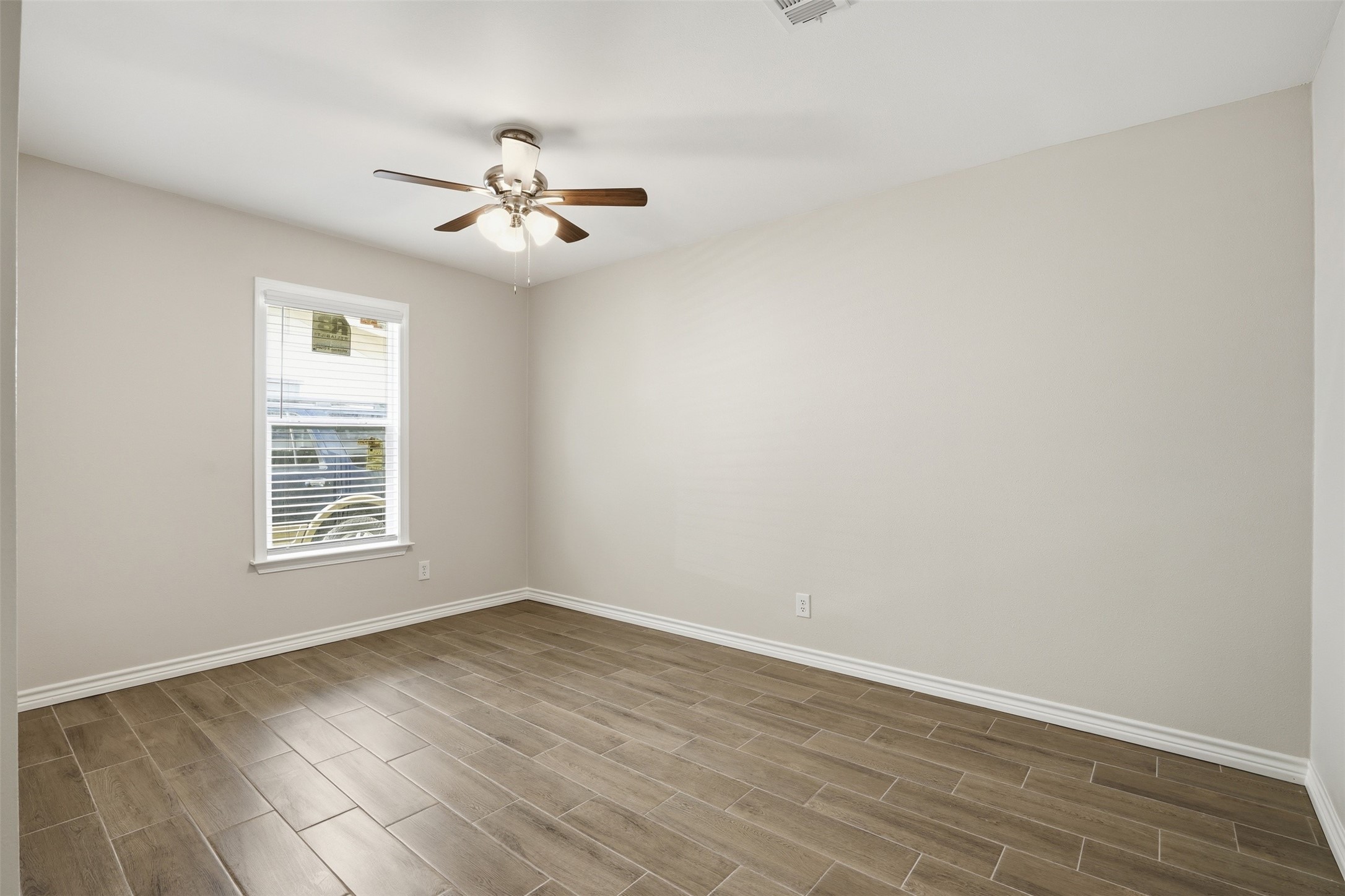 6518 Paris Street Houston, TX 77021 - Photo 14 of 23 wooden floor in an empty room with a window