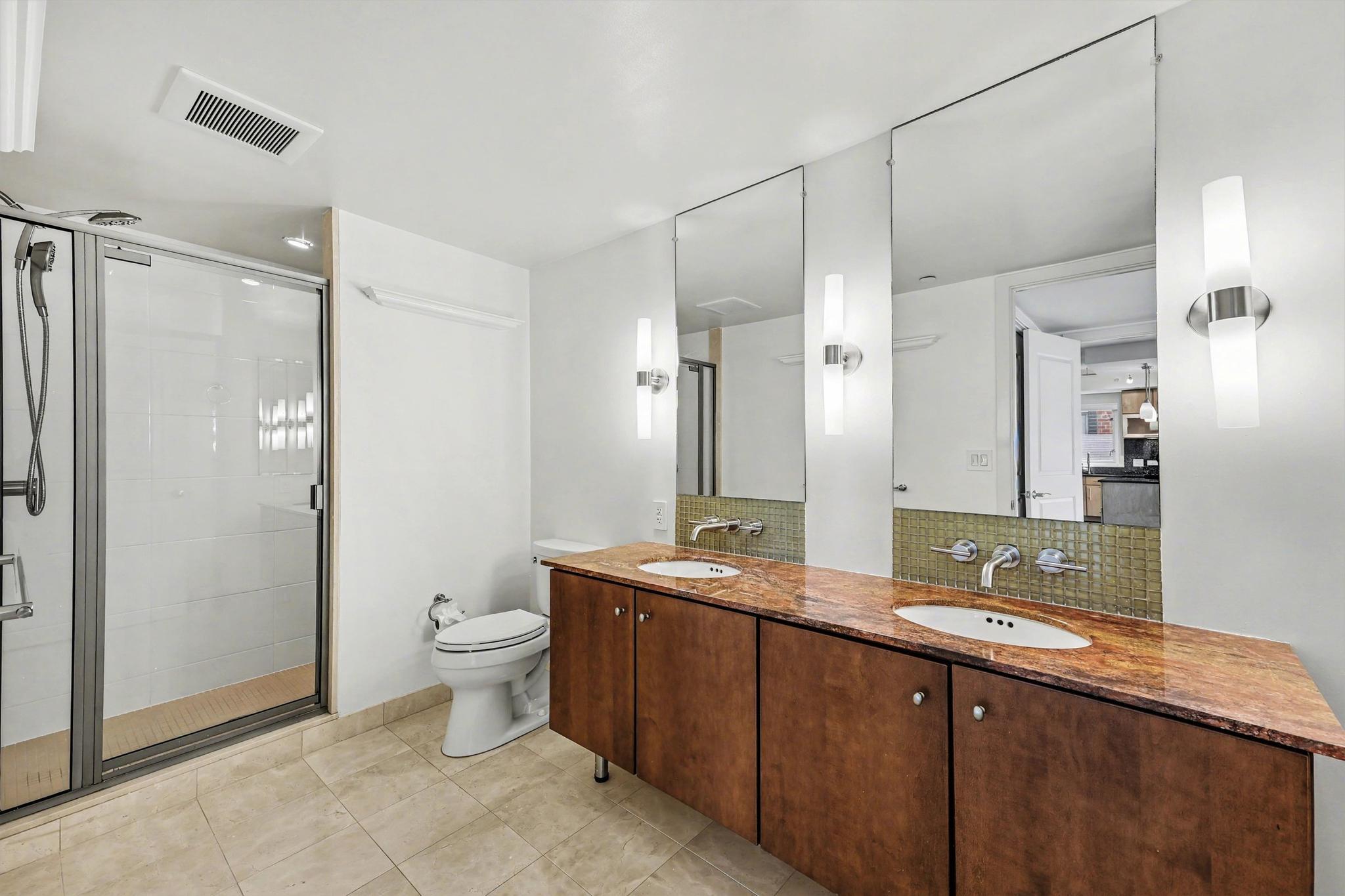 1025 First Street Southeast, Unit 906 Washington, DC 20003 - Photo 13 of 34 a bathroom with a double vanity sink toilet and shower