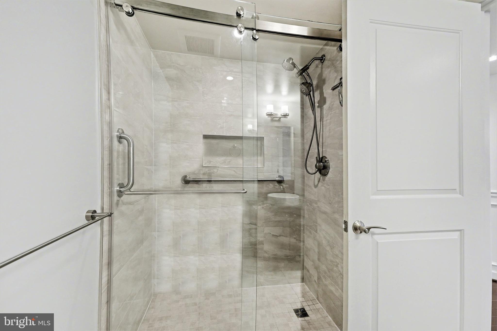 1025 First Street Southeast, Unit 906 Washington, DC 20003 - Photo 20 of 34 a bathroom with a glass shower door