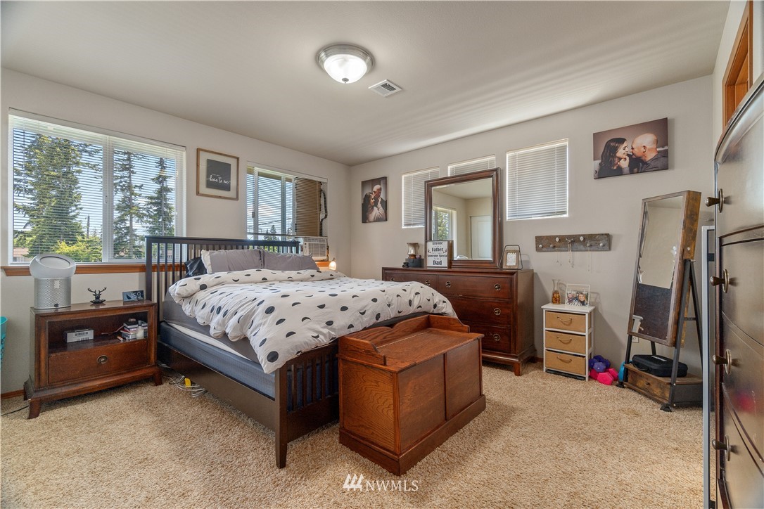 6309 199th Loop Southwest Rochester, WA 98579 - Photo 22 of 27 a bedroom with a bed and a dresser