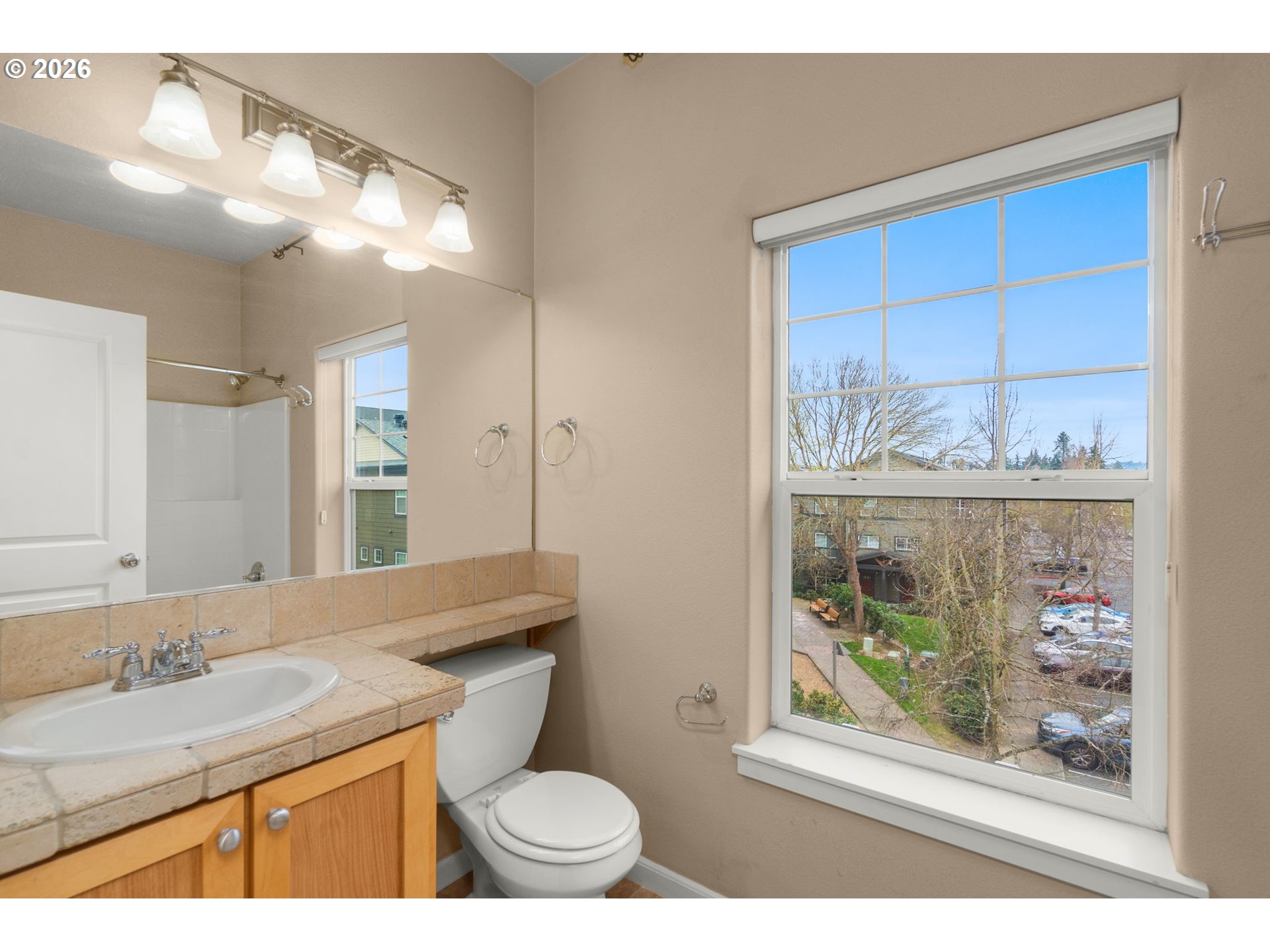 1060 Southwest 170th Avenue, Unit 202 Beaverton, OR 97003 - Photo 21 of 27 a bathroom with a granite countertop sink mirror vanity and toilet