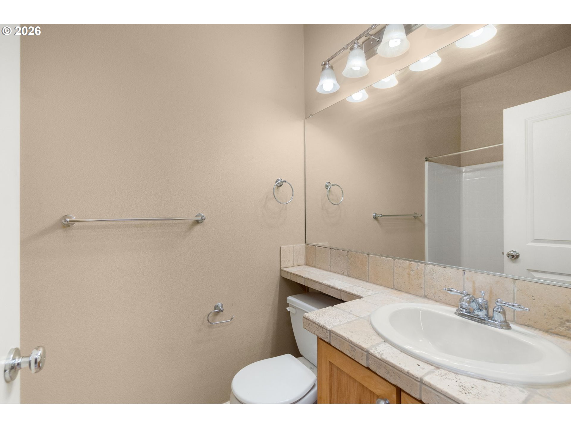 1060 Southwest 170th Avenue, Unit 202 Beaverton, OR 97003 - Photo 25 of 27 a bathroom with a sink toilet and mirror
