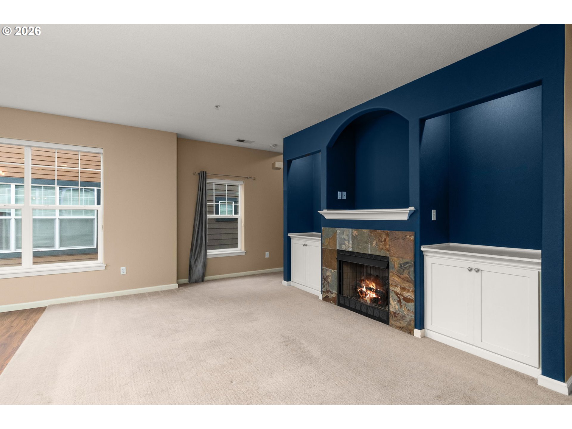 1060 Southwest 170th Avenue, Unit 202 Beaverton, OR 97003 - Photo 6 of 27 a view of an empty room with a fireplace and a window