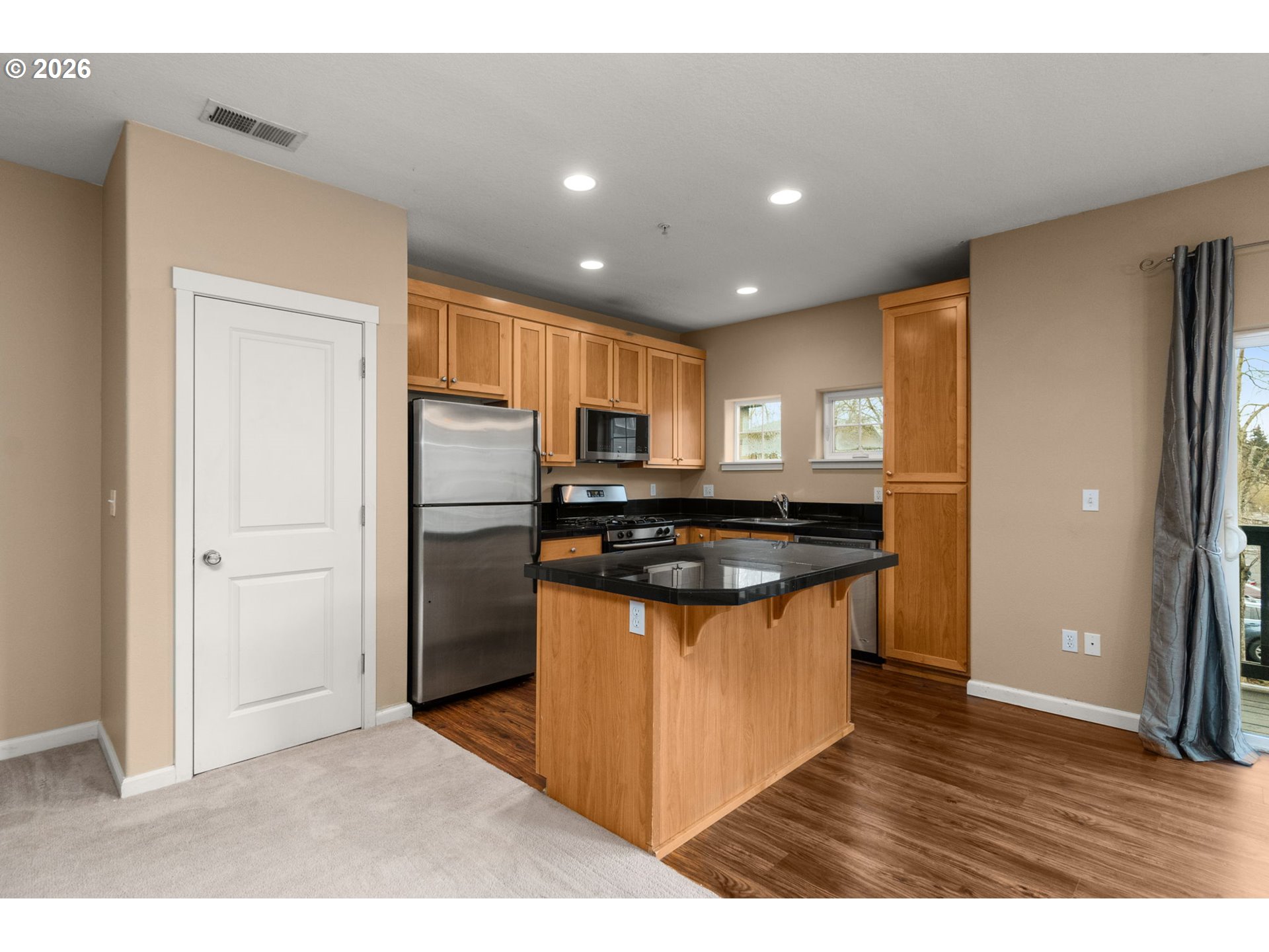 1060 Southwest 170th Avenue, Unit 202 Beaverton, OR 97003 - Photo 8 of 27 a kitchen with stainless steel appliances granite countertop a refrigerator and a stove top oven