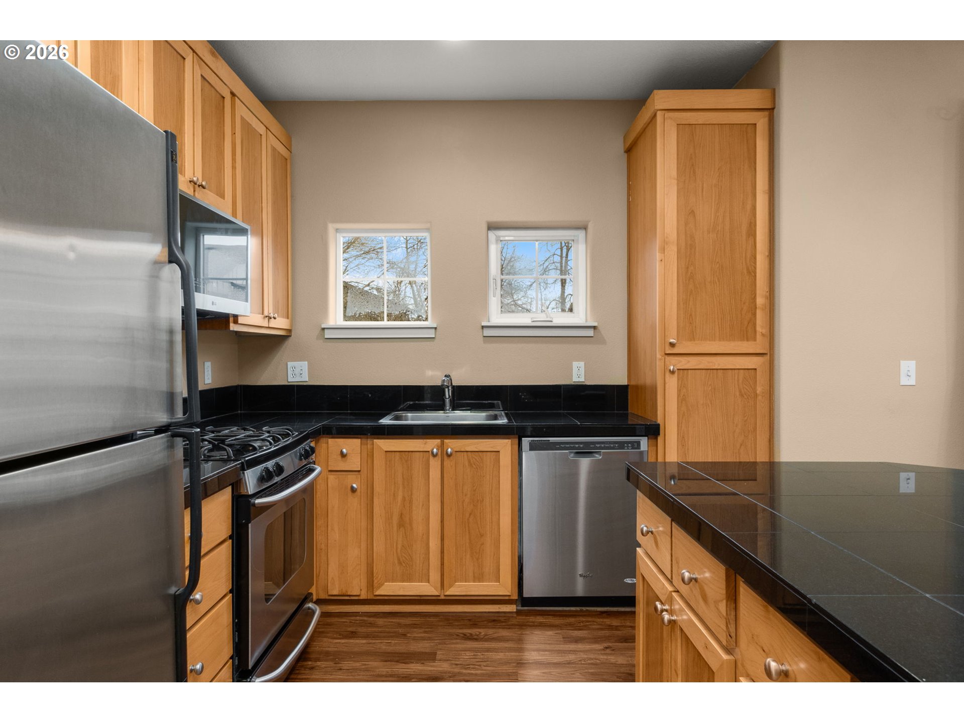 1060 Southwest 170th Avenue, Unit 202 Beaverton, OR 97003 - Photo 9 of 27 a kitchen with stainless steel appliances granite countertop a sink stove and refrigerator