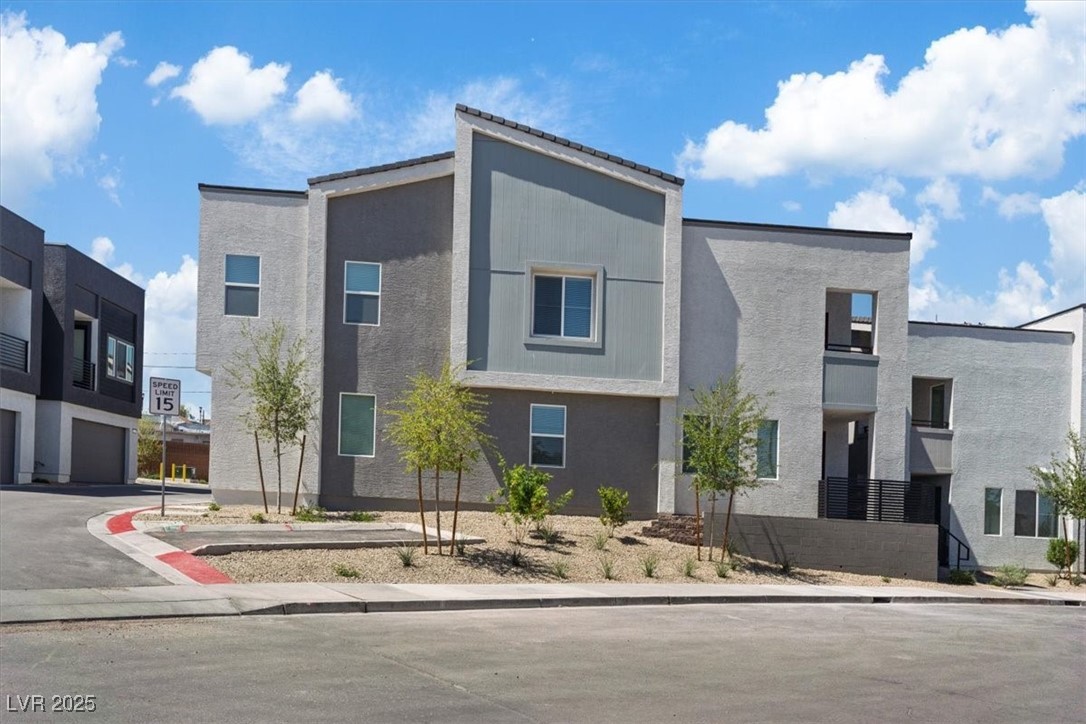 Contemporary house with stucco siding and a residential view