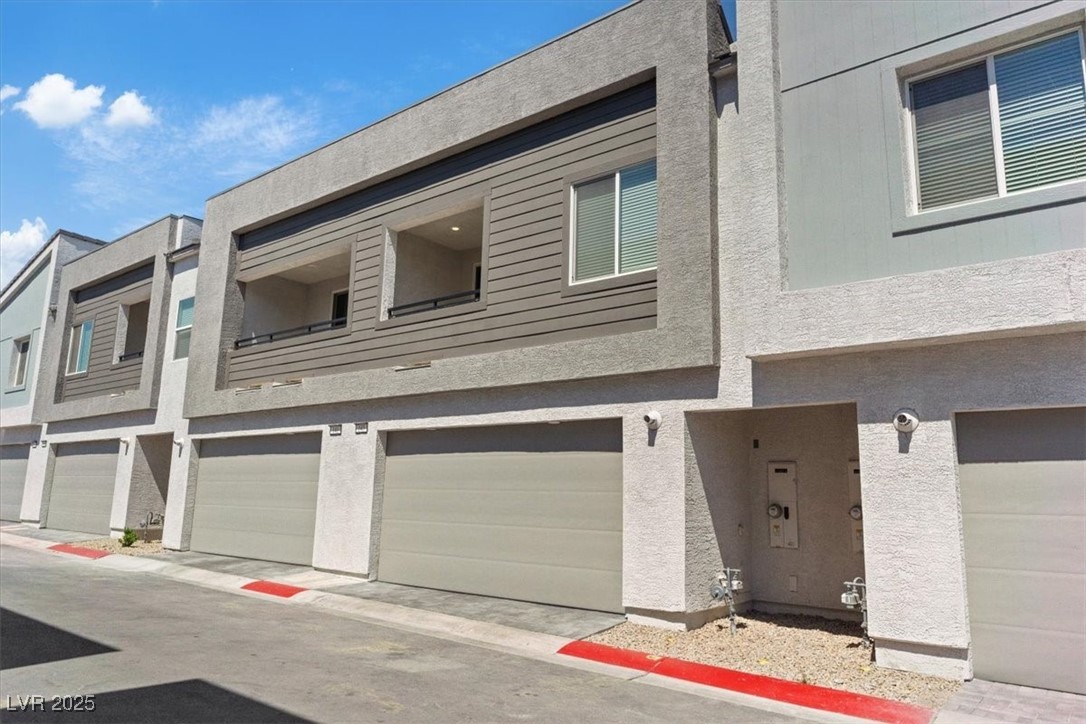 143 Aqua Commons Lane Henderson, NV 89015 - Photo 12 of 20 View of building exterior with an attached garage