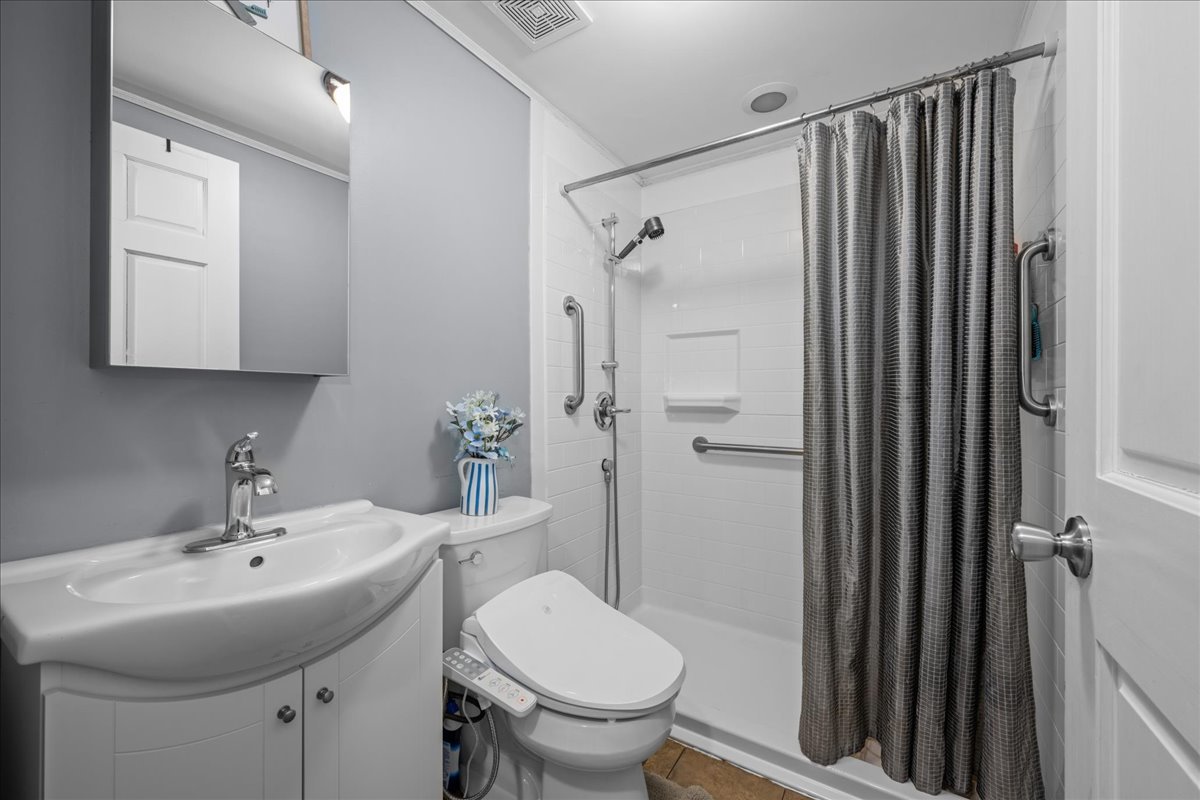 207 Second Street Elgin, IL 60123 - Photo 13 of 16 a bathroom with a sink toilet and shower