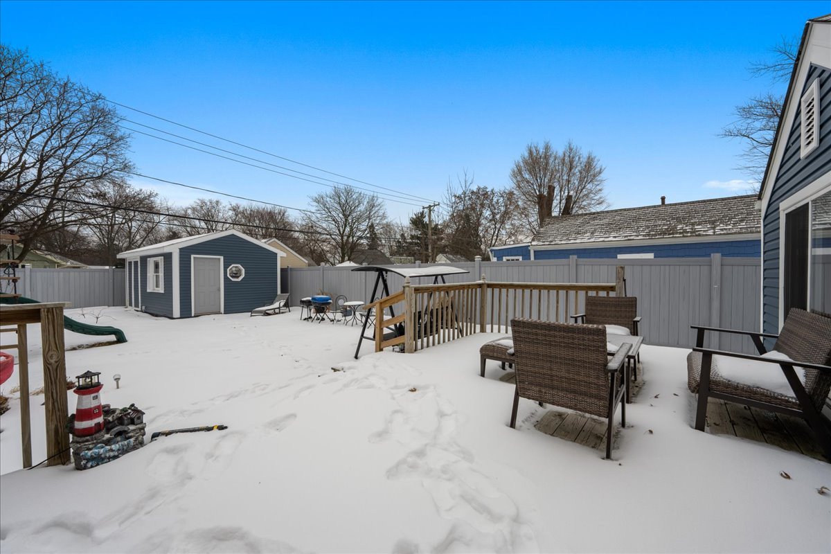 207 Second Street Elgin, IL 60123 - Photo 14 of 16 a view of a terrace with chairs and wooden fence