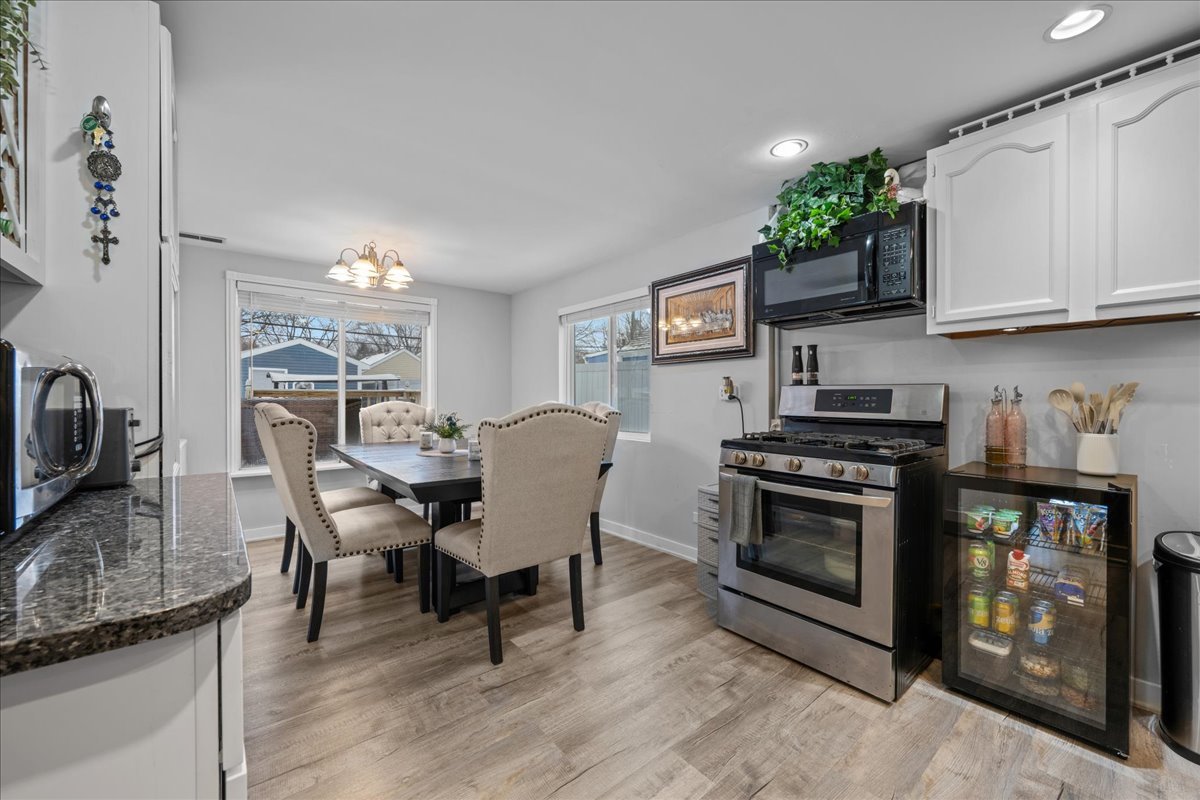 207 Second Street Elgin, IL 60123 - Photo 6 of 16 a view of a dining room with furniture and wooden floor