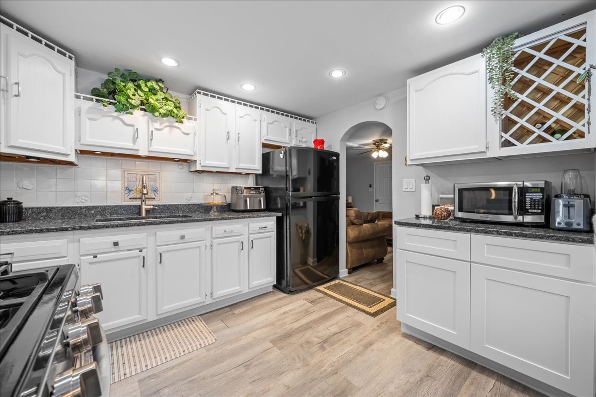 207 Second Street Elgin, IL 60123 - Photo 7 of 16 a kitchen with stainless steel appliances granite countertop a refrigerator sink and cabinets