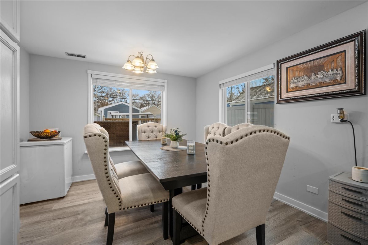 207 Second Street Elgin, IL 60123 - Photo 8 of 16 a dining room with furniture a window and wooden floor