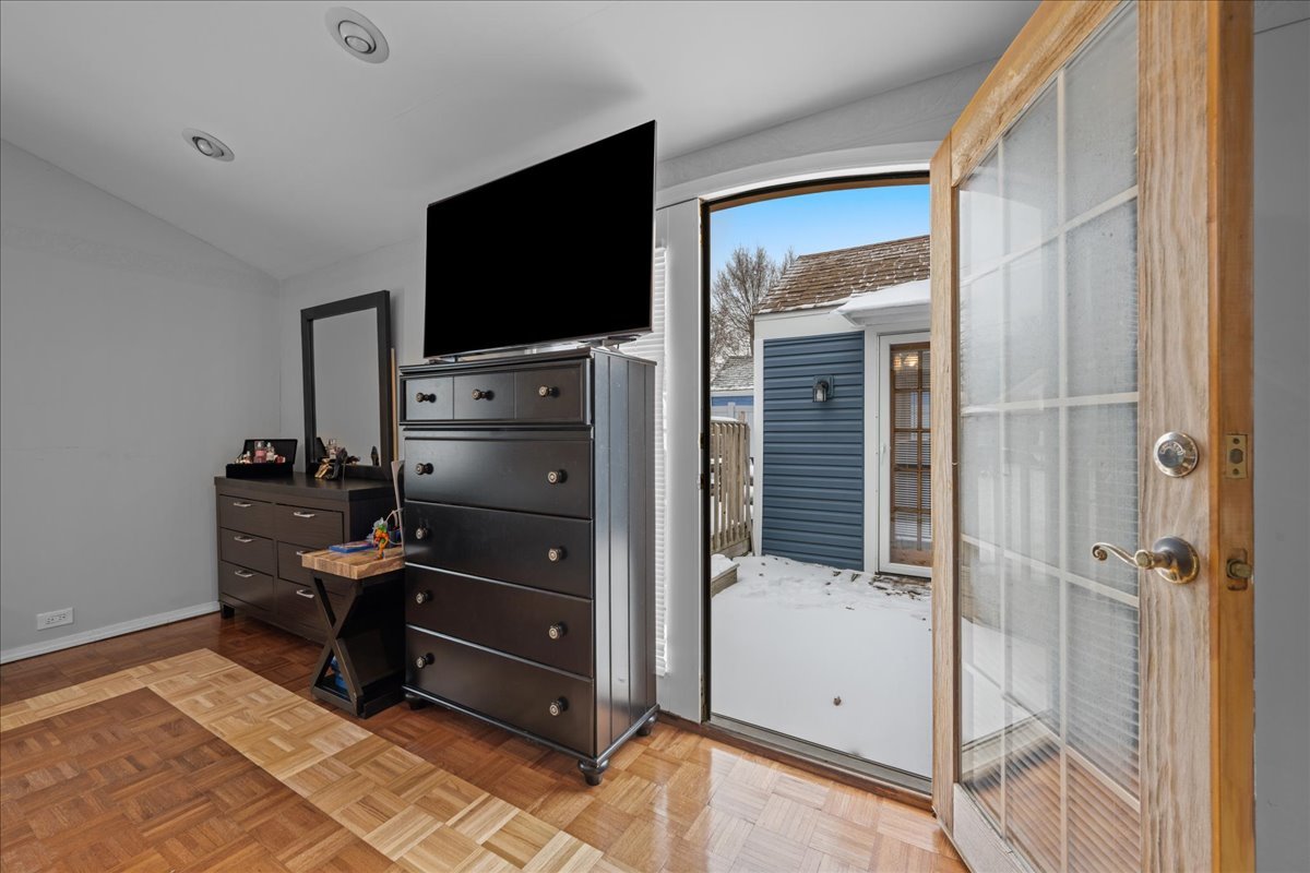 207 Second Street Elgin, IL 60123 - Photo 10 of 16 a room with a flat tv screen and a dresser