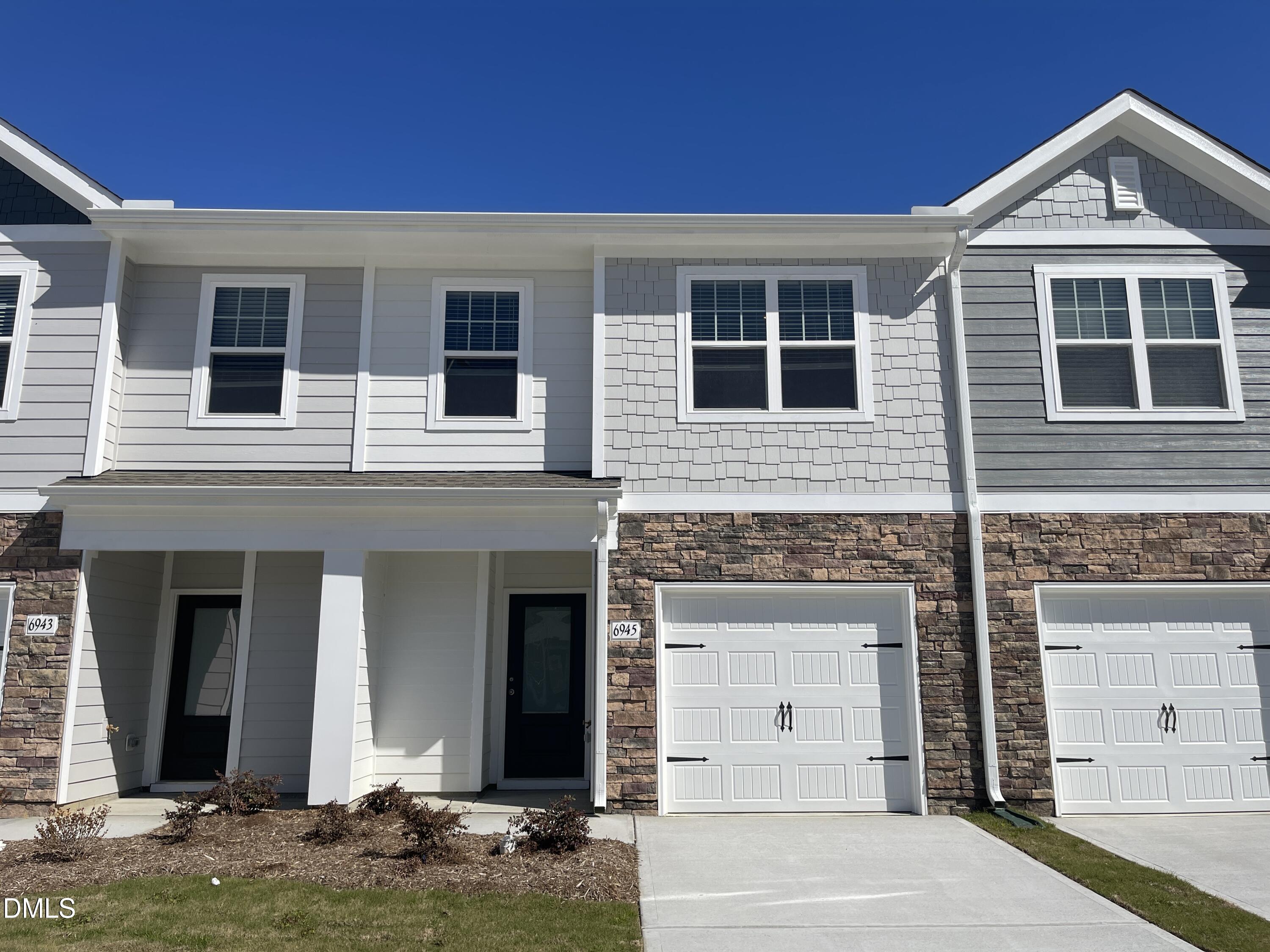 6945 Outfall Point Lane Raleigh, NC 27616 - Photo 1 of 23 a front view of a house with yard