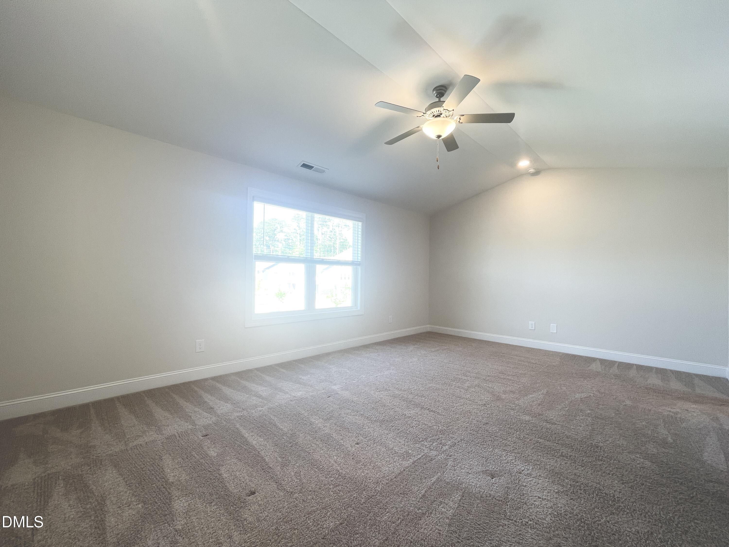 6945 Outfall Point Lane Raleigh, NC 27616 - Photo 11 of 23 an empty room with windows and fan