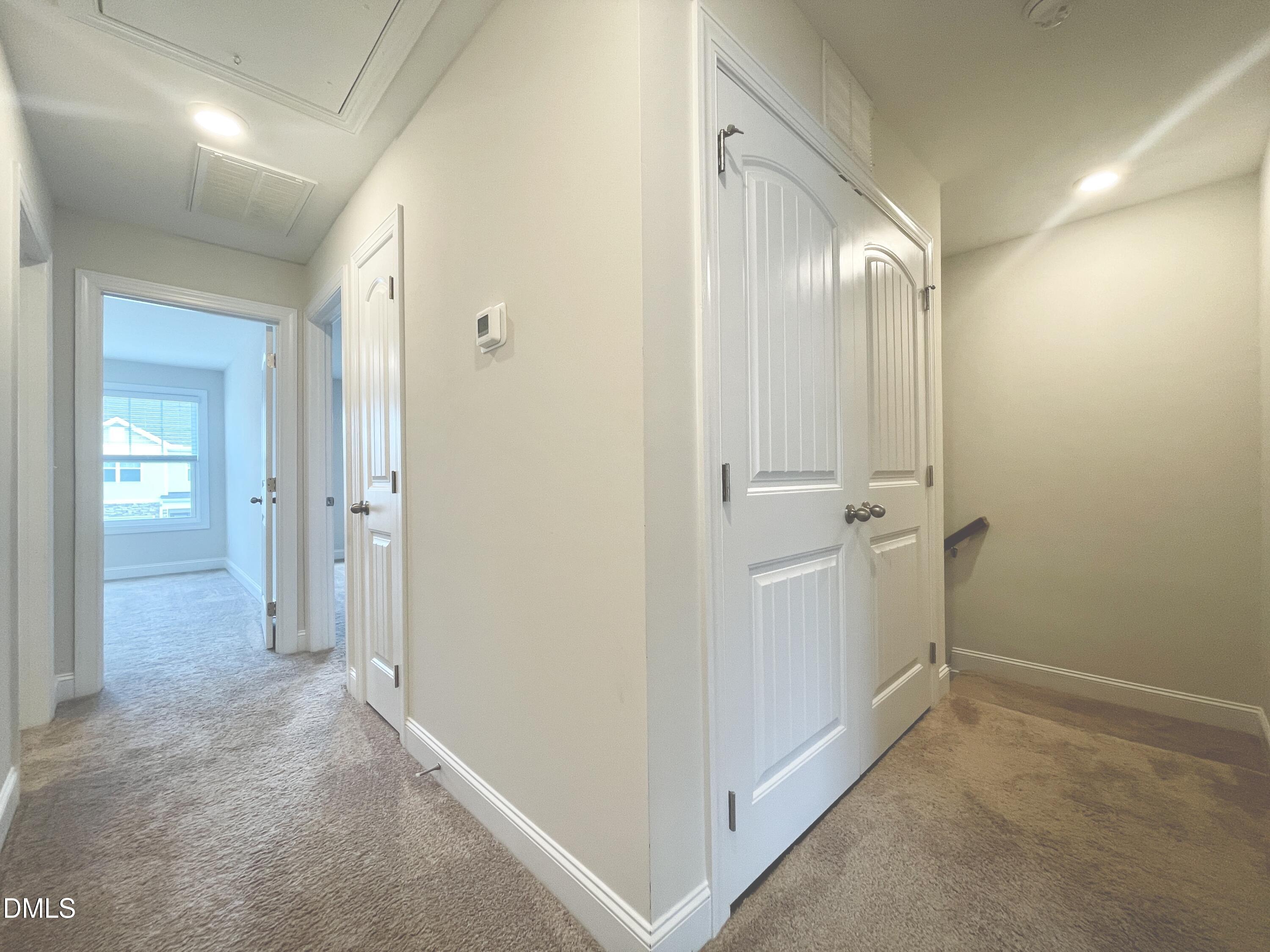 6945 Outfall Point Lane Raleigh, NC 27616 - Photo 13 of 23 a view of a hallway with closet and bathroom