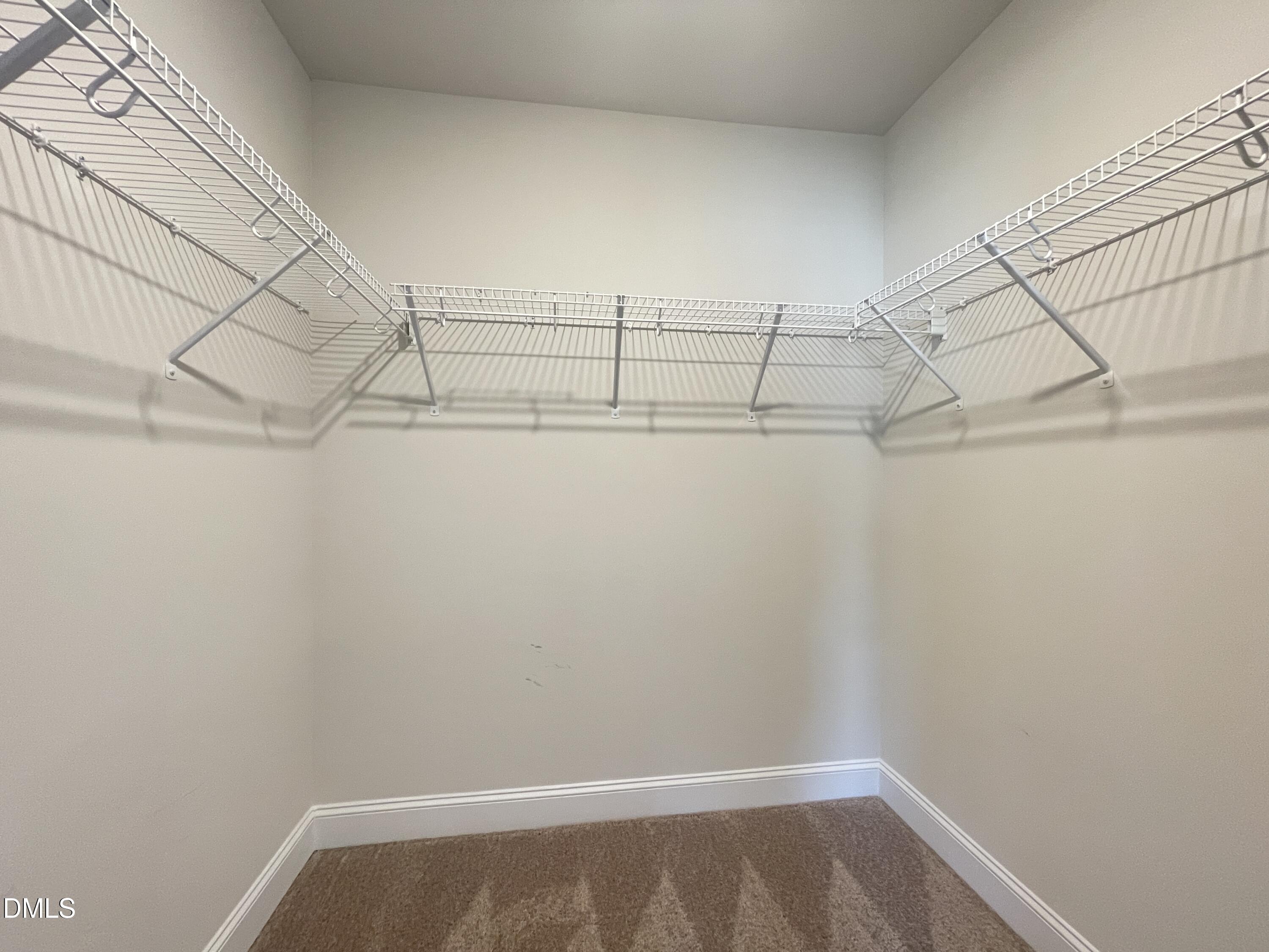 6945 Outfall Point Lane Raleigh, NC 27616 - Photo 14 of 23 a view of a room with racks on the wall