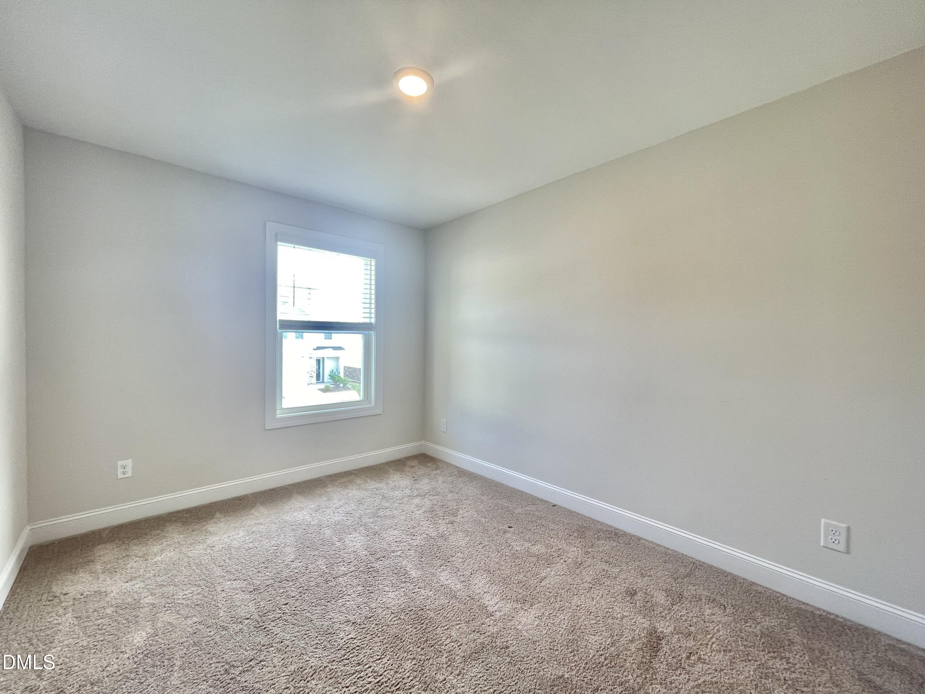 6945 Outfall Point Lane Raleigh, NC 27616 - Photo 17 of 23 an empty room with a window