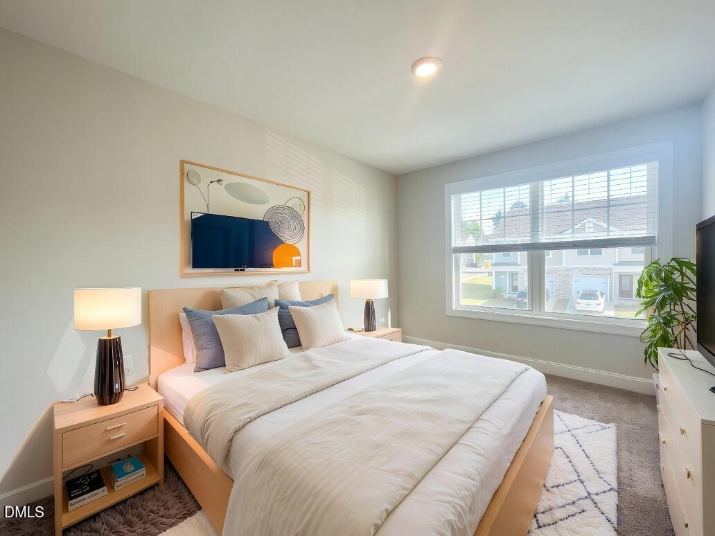 6945 Outfall Point Lane Raleigh, NC 27616 - Photo 20 of 23 a bedroom with a bed and a large window