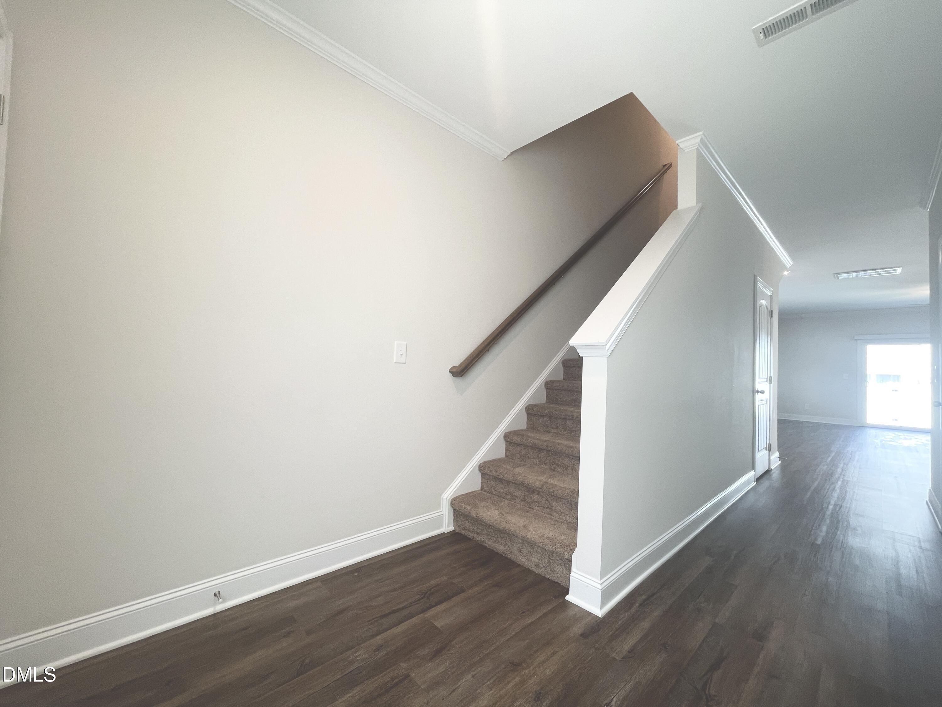 6945 Outfall Point Lane Raleigh, NC 27616 - Photo 2 of 23 a view of a hallway with wooden floor