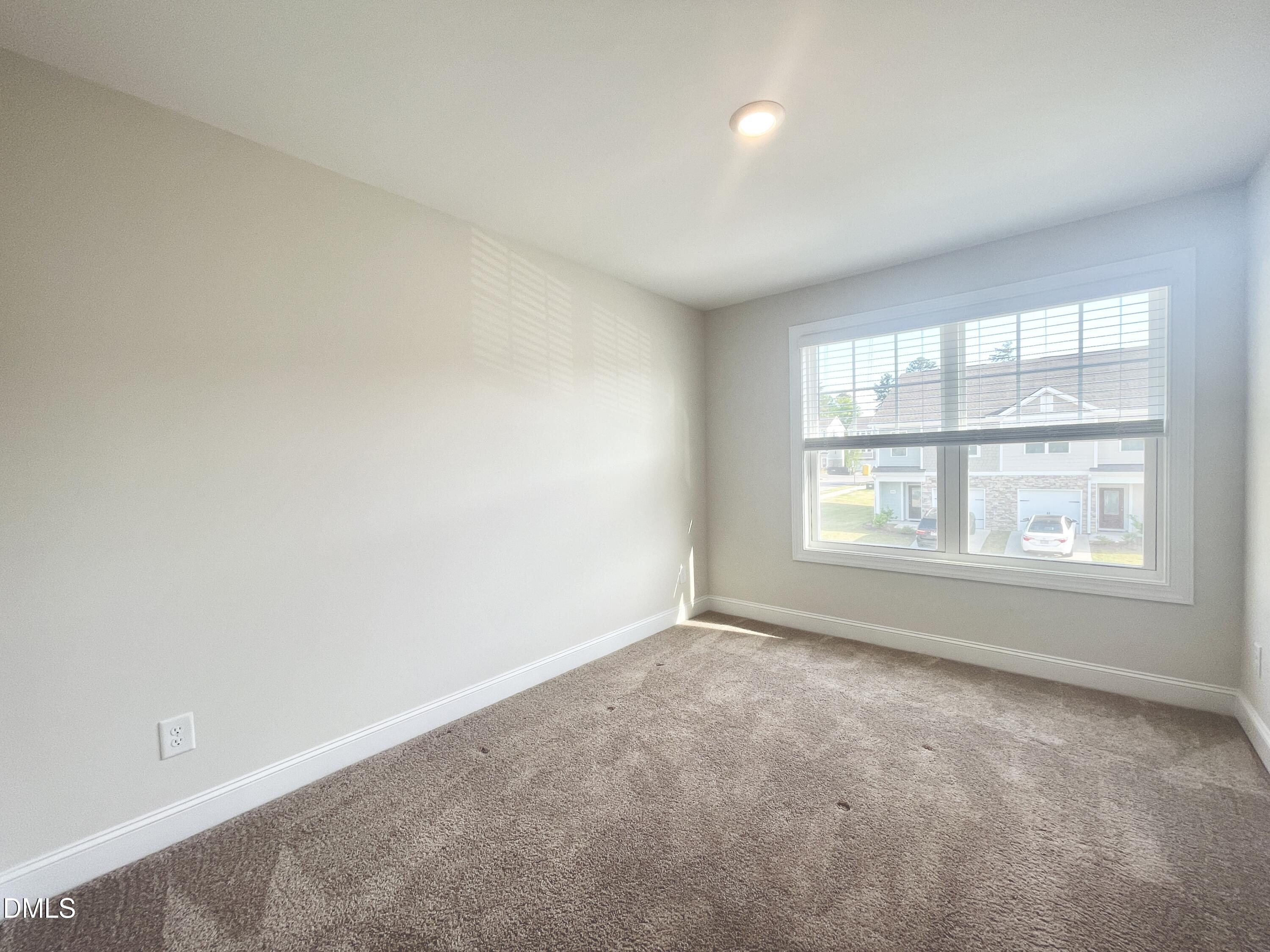 6945 Outfall Point Lane Raleigh, NC 27616 - Photo 21 of 23 an empty room with a window