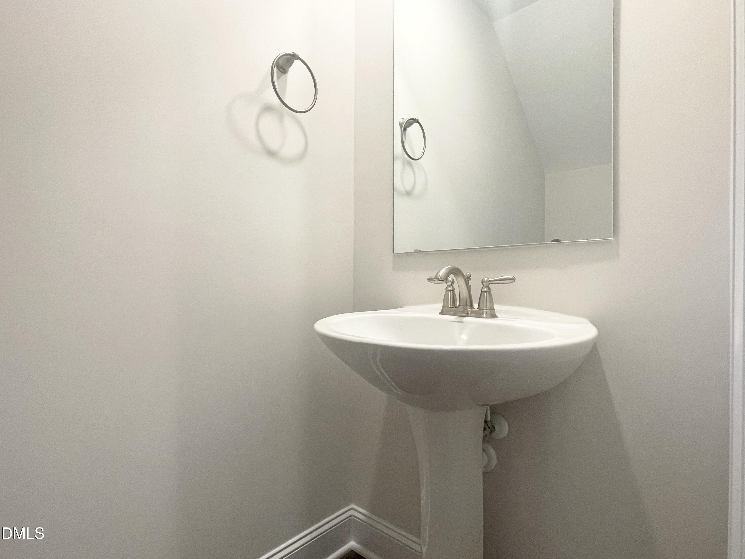6945 Outfall Point Lane Raleigh, NC 27616 - Photo 9 of 23 a sink with a mirror