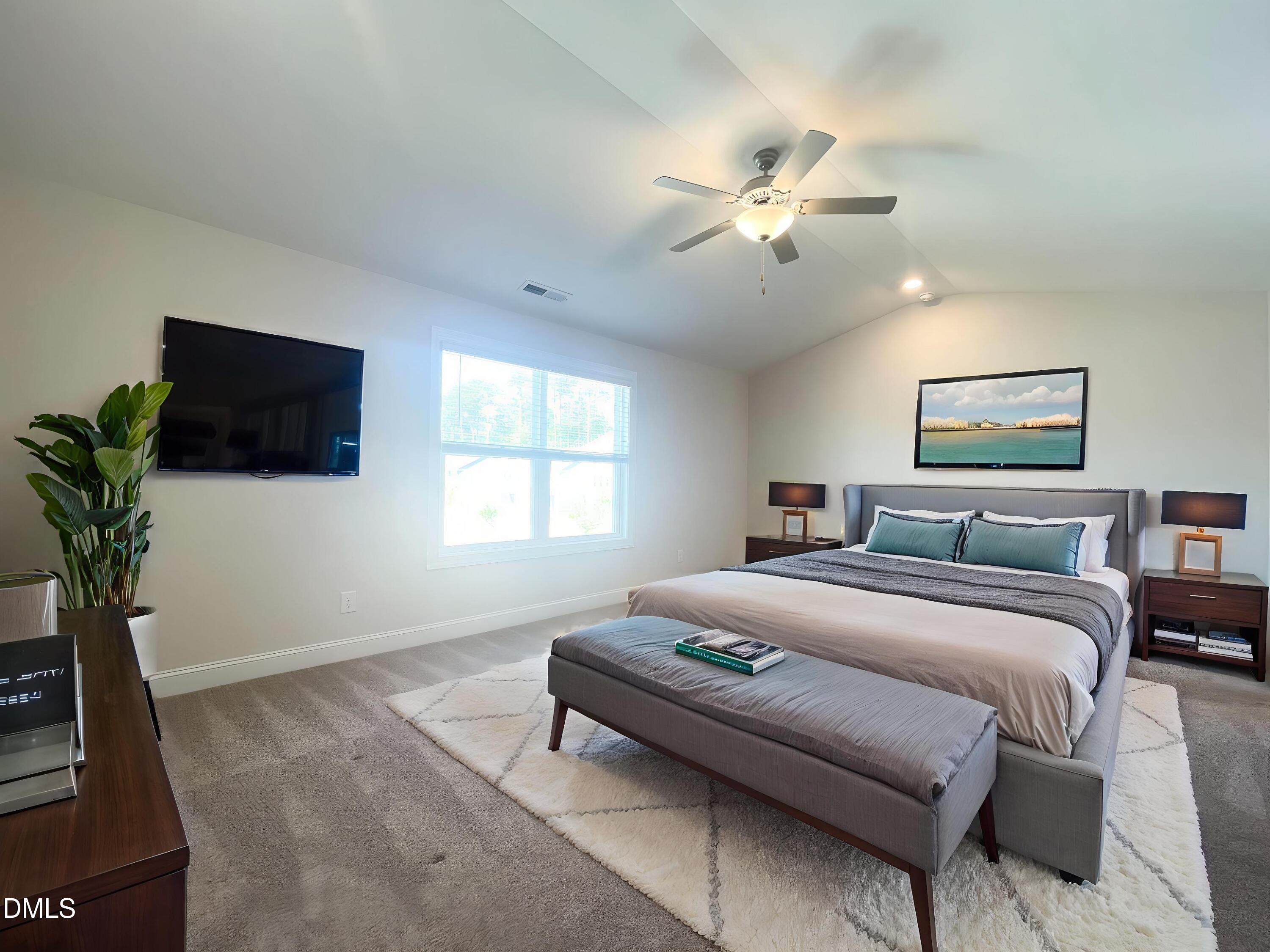 6945 Outfall Point Lane Raleigh, NC 27616 - Photo 10 of 23 a bedroom with a bed and a flat screen tv