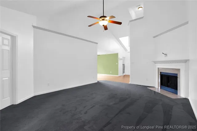 a view of an empty room with a fireplace