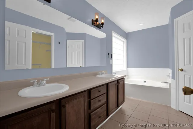 a bathroom with a granite countertop sink a bathtub a mirror and a shower