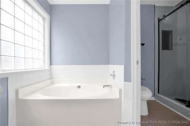a bathroom with a bathtub and a window