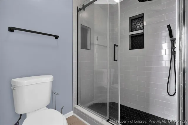 a bathroom with a toilet and a shower