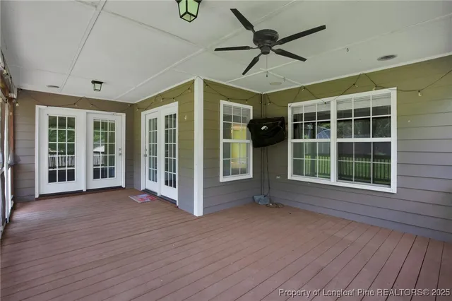 a view of an empty room with a large window wooden floor and a window