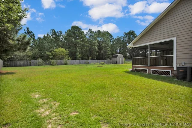 a view of a swimming pool with a yard