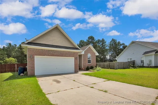 a front view of house with yard and garage