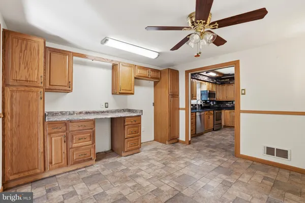 a large kitchen with cabinets and stainless steel appliances